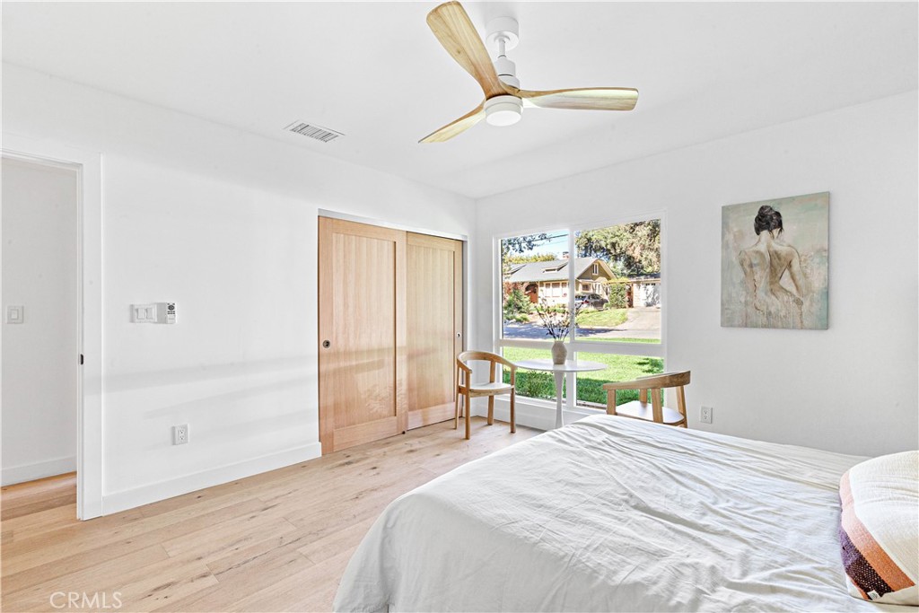 950 Morada Place Altadena, CA 91001 - Photo 17 of 30 a bedroom with a bed a table and painting on the wall