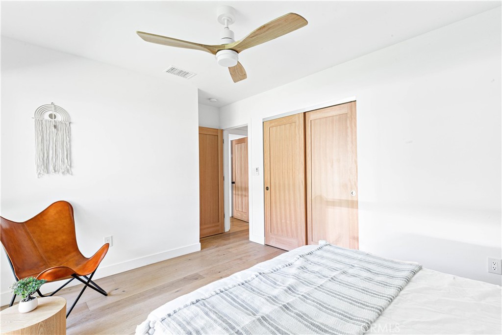 950 Morada Place Altadena, CA 91001 - Photo 21 of 30 a bedroom with a bed and a chair