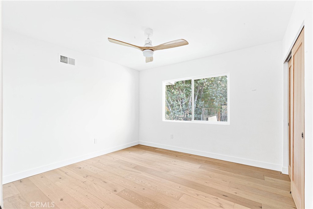 950 Morada Place Altadena, CA 91001 - Photo 23 of 30 an empty room with wooden floor and windows