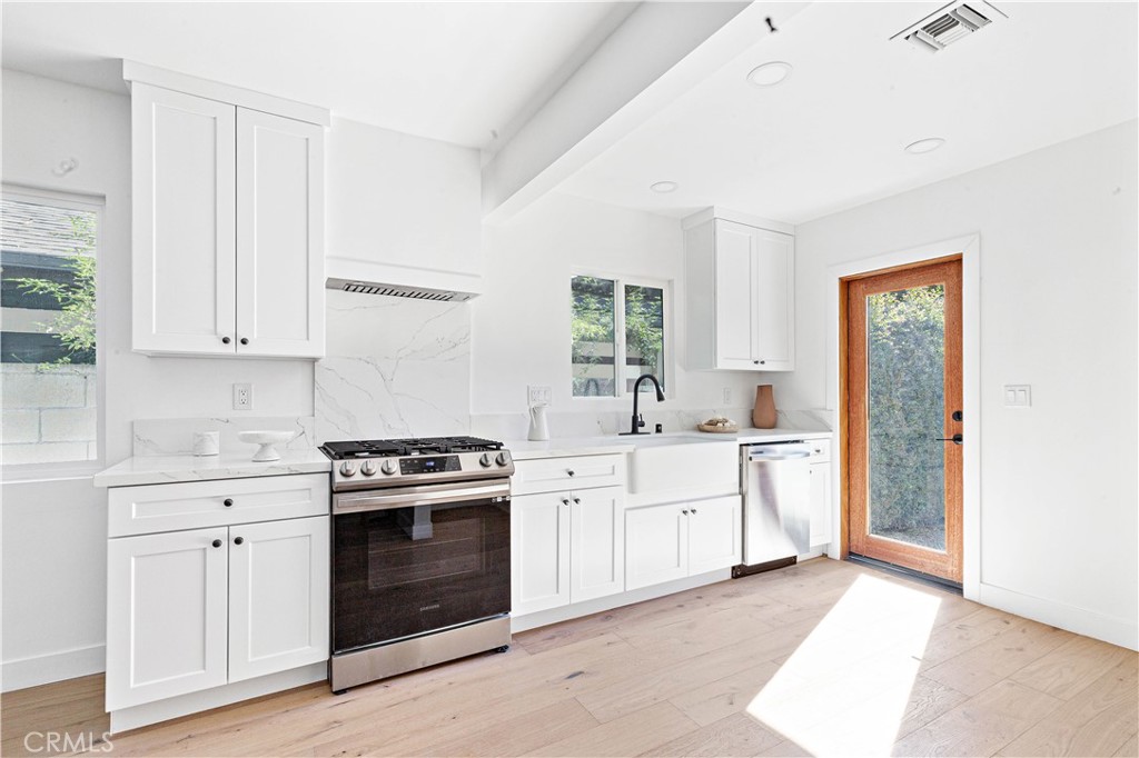950 Morada Place Altadena, CA 91001 - Photo 9 of 30 a kitchen with white cabinets and white appliances