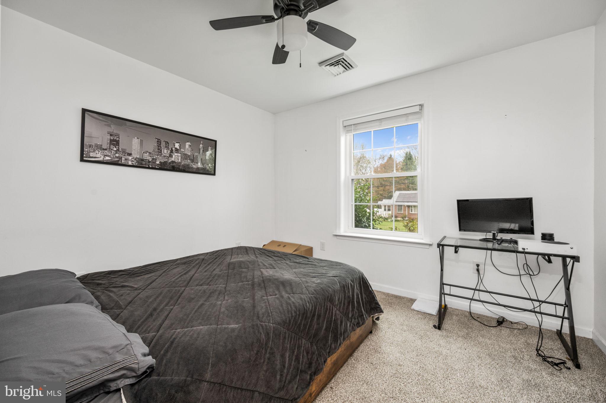 1915 Larkin Road Upper Chichester, PA 19061 - Photo 16 of 23 a bedroom with a bed and a flat screen tv