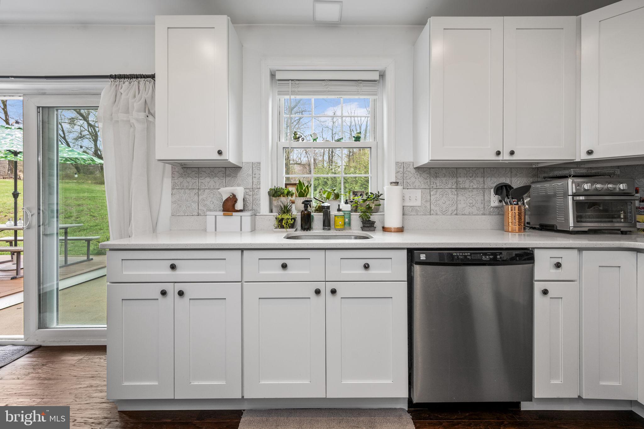 1915 Larkin Road Upper Chichester, PA 19061 - Photo 4 of 23 a kitchen with white cabinets and a window