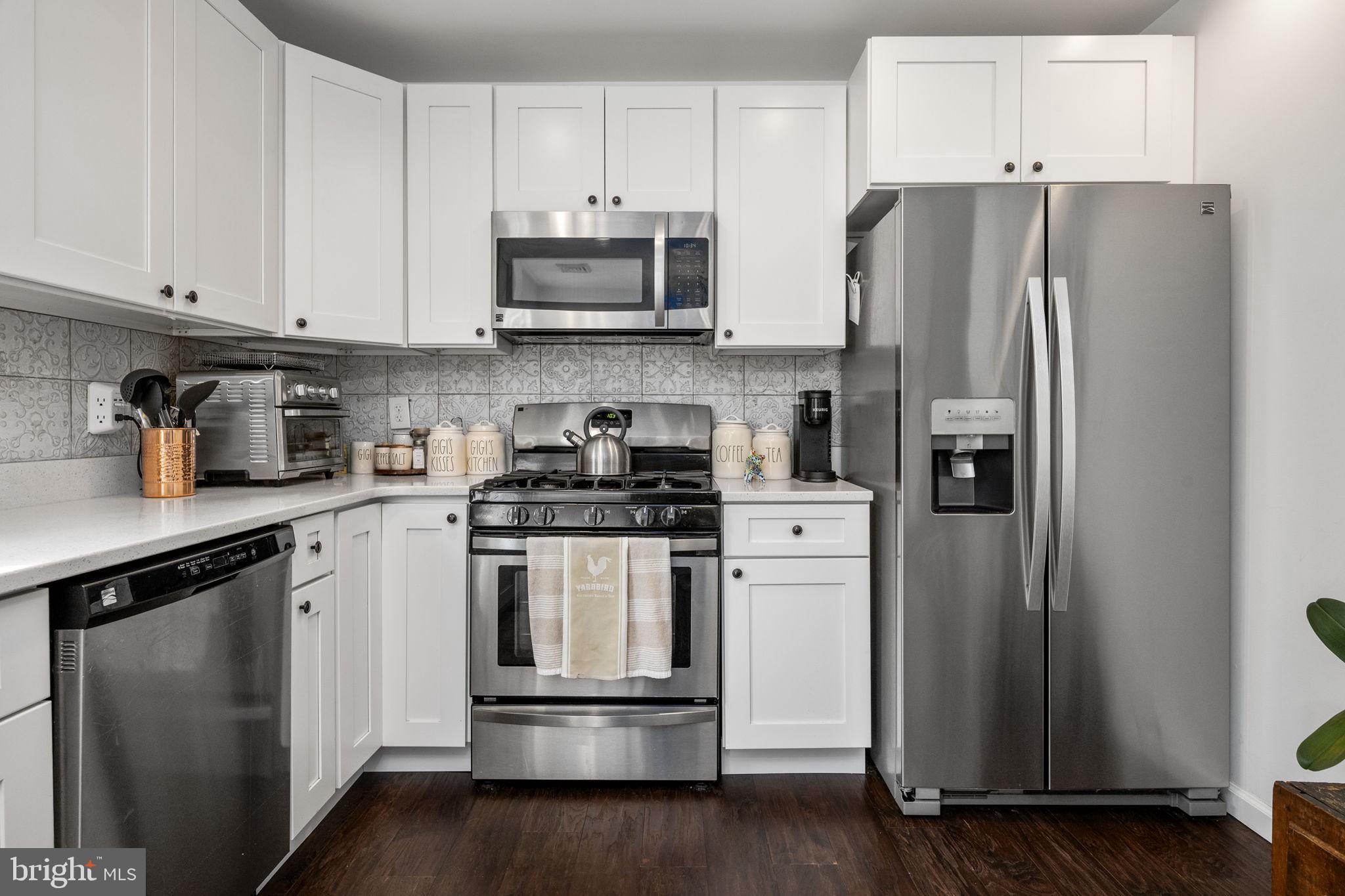 1915 Larkin Road Upper Chichester, PA 19061 - Photo 6 of 23 a kitchen with stainless steel appliances a refrigerator stove and microwave