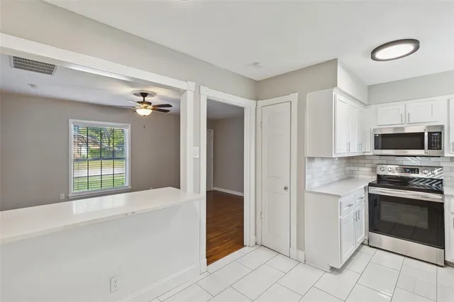 a kitchen with stainless steel appliances granite countertop a stove and a refrigerator