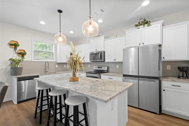 a kitchen with a table chairs refrigerator and microwave