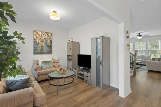 a view of a hallway with wooden floor and stairs