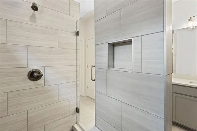 a spacious bathroom with a double vanity sink a mirror and a shower