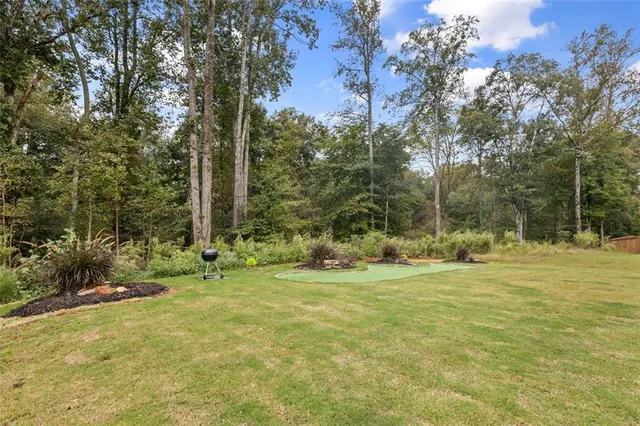 a view of a house with a yard and sitting area