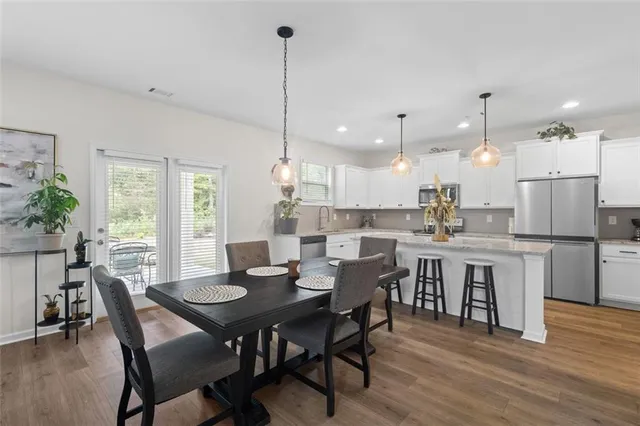 a dining room with kitchen island a table and chairs
