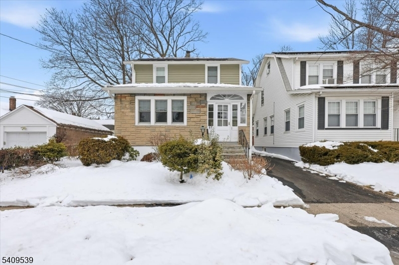 57 Menzel Avenue Maplewood, NJ 07040 - Photo 1 of 21 a front view of a house with a yard covered with snow