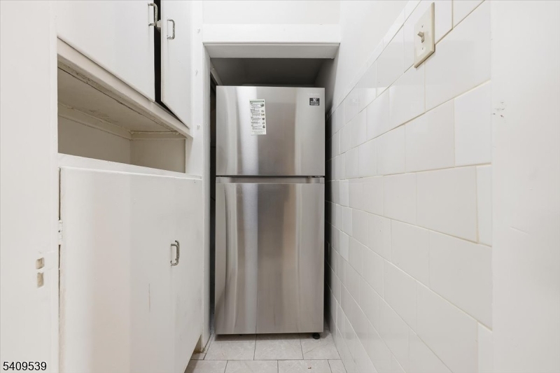 57 Menzel Avenue Maplewood, NJ 07040 - Photo 13 of 21 a white refrigerator freezer and a dishwasher sitting inside of a kitchen