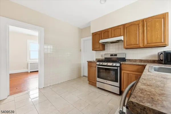 a kitchen with a stove top oven and cabinets