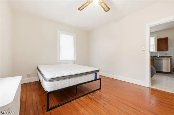 a room with wooden floor and window