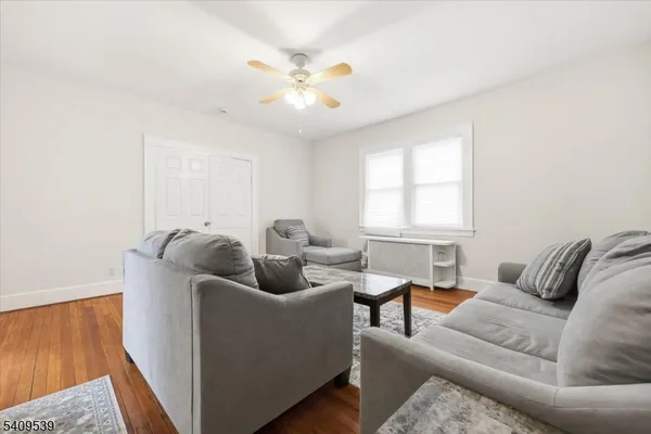 a living room with furniture and a chandelier