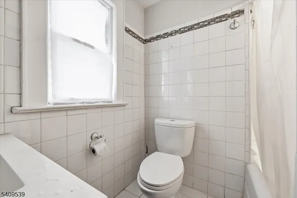 a white toilet sitting next to a bathroom sink