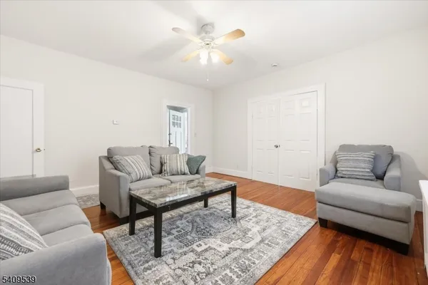a living room with furniture and a wooden floor