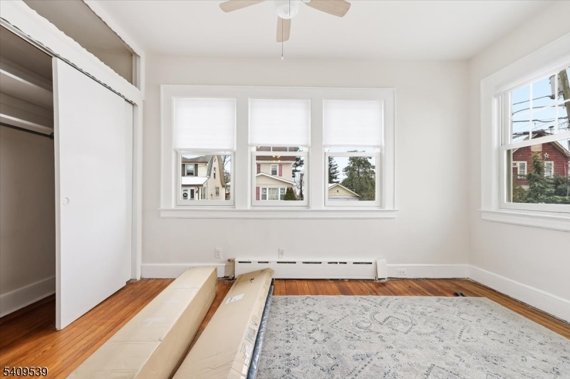 57 Menzel Avenue Maplewood, NJ 07040 - Photo 7 of 21 a view of an empty room with a window and wooden floor