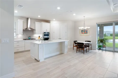 a kitchen with stainless steel appliances and white cabinets
