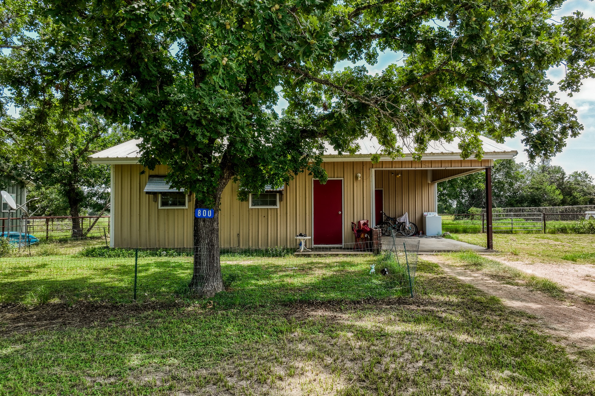 800 Waldeck Road Ledbetter, TX 78946 - Photo 2 of 6 a view of a house with a yard and large tree