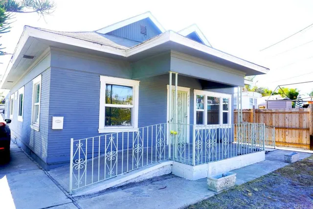 a porch with a bench next to a yard