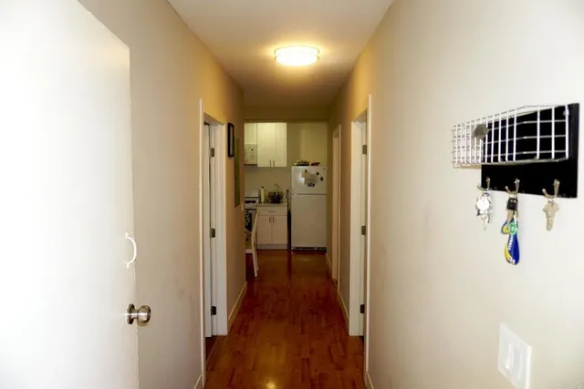 a view of a hallway with wooden floor