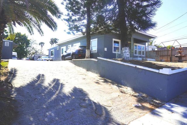 a view of a house with a yard covered in snow