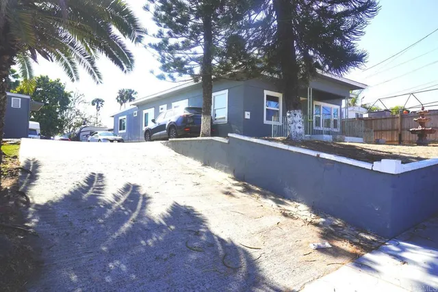 a view of a house with a yard covered in snow
