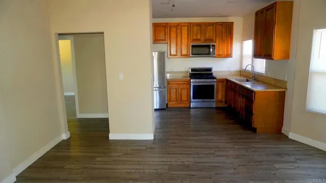 a kitchen with granite countertop a stove and a refrigerator
