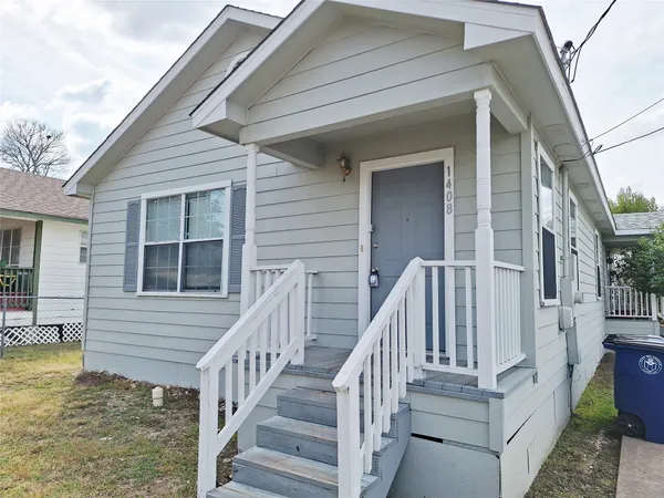 a view of a house with wooden floor fence and a porch