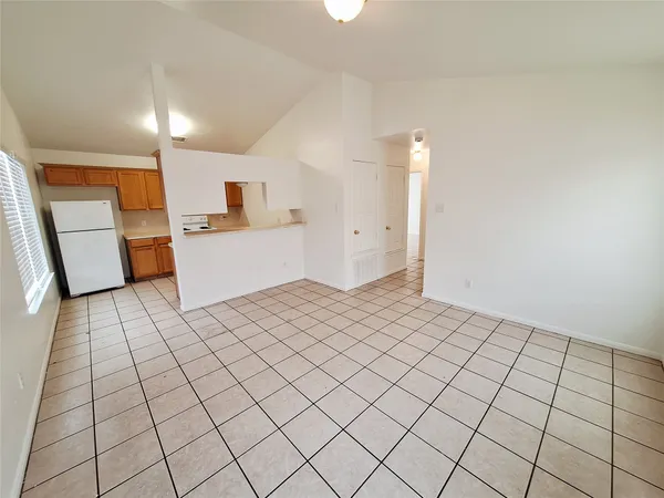 a large white room with a white cabinet and a sink