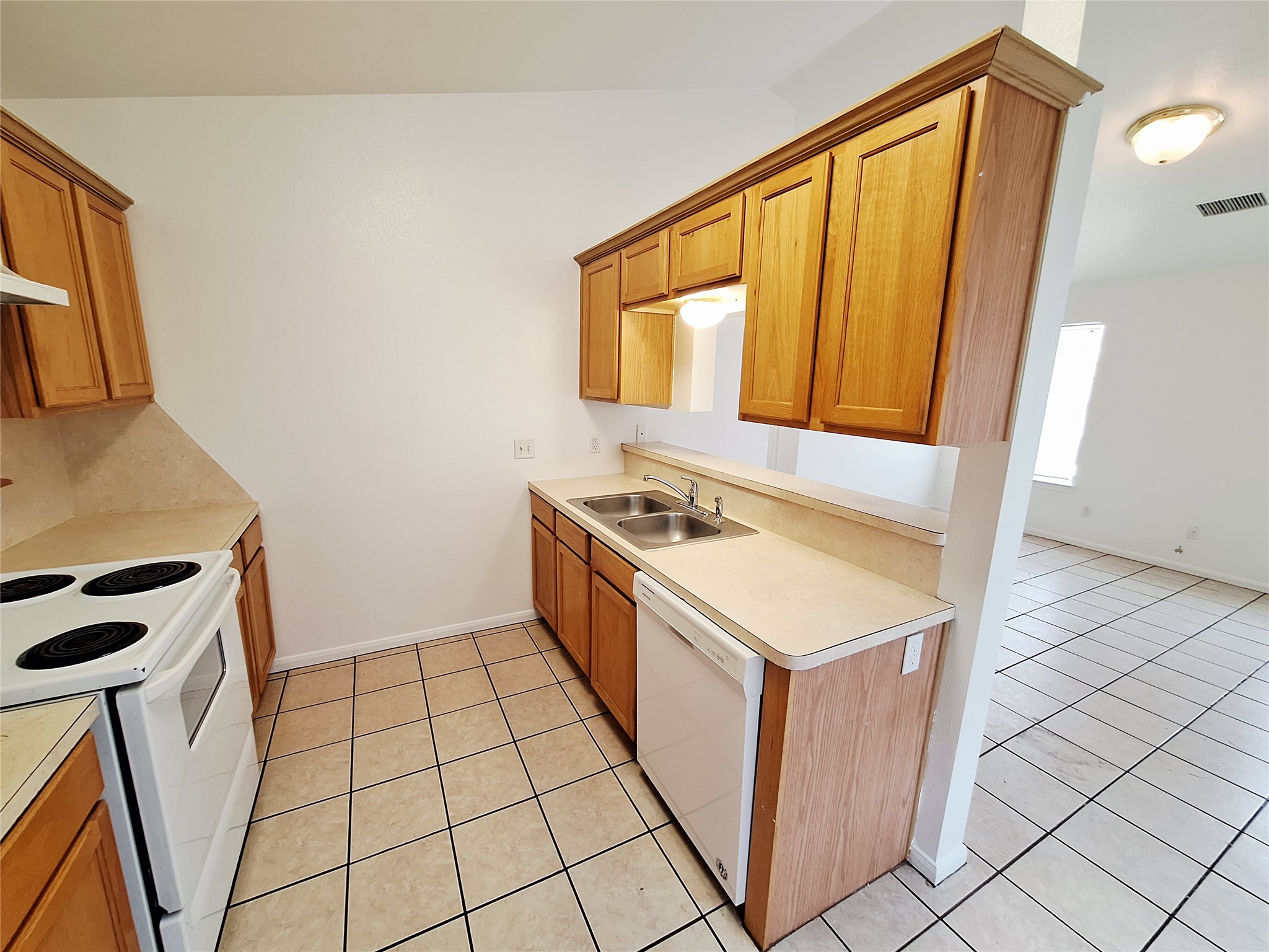 1408 Perez Street, Unit A Austin, TX 78721 - Photo 6 of 12 a kitchen with a stove a sink and a refrigerator