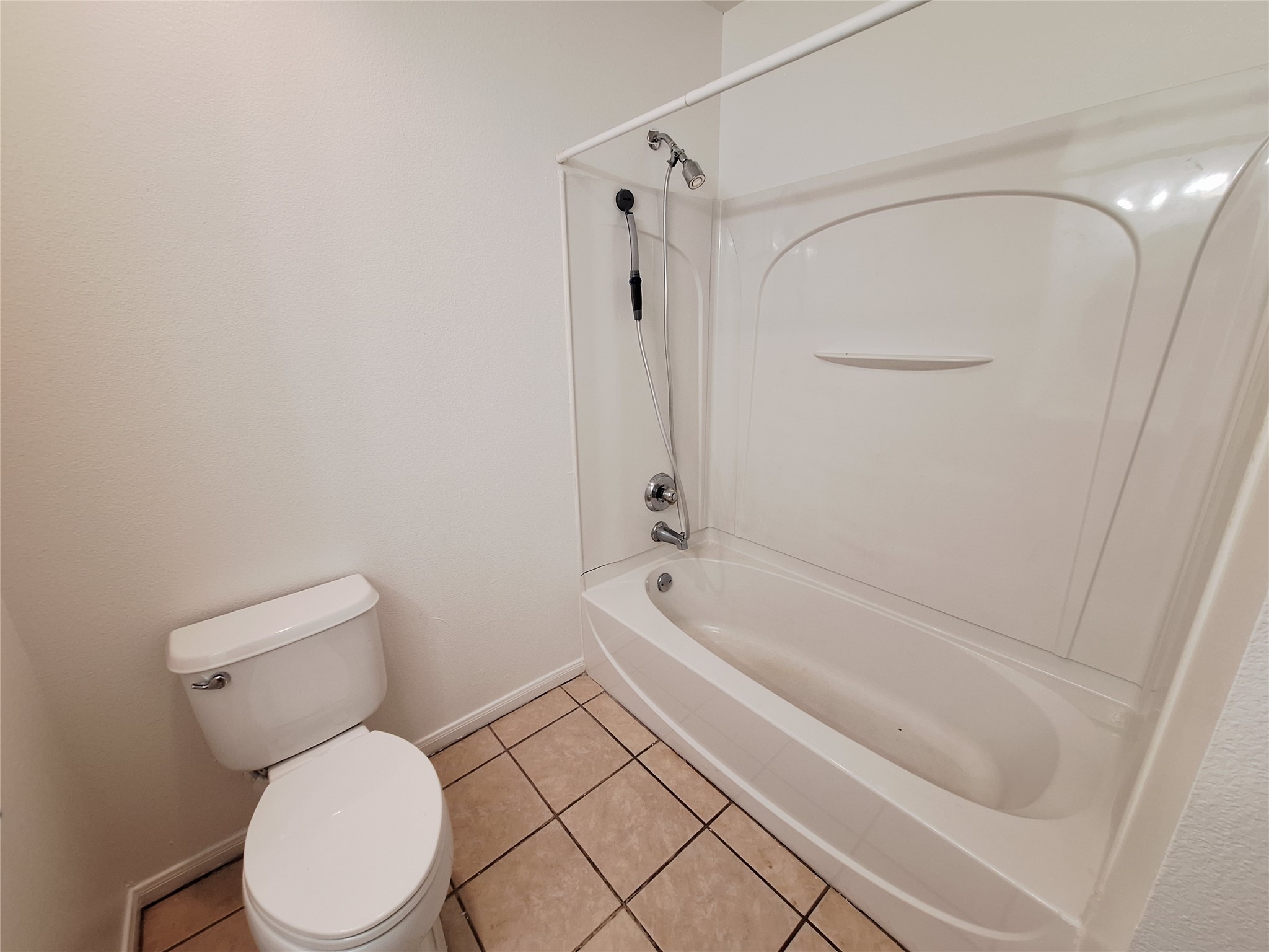 1408 Perez Street, Unit A Austin, TX 78721 - Photo 10 of 12 a bathroom with a toilet and a bathtub