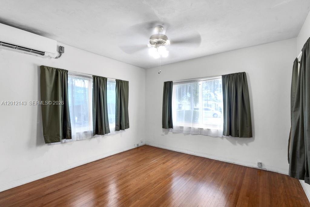 5651 Northwest 3rd Street Miami, FL 33126 - Photo 14 of 21 a view of an empty room with wooden floor and a window
