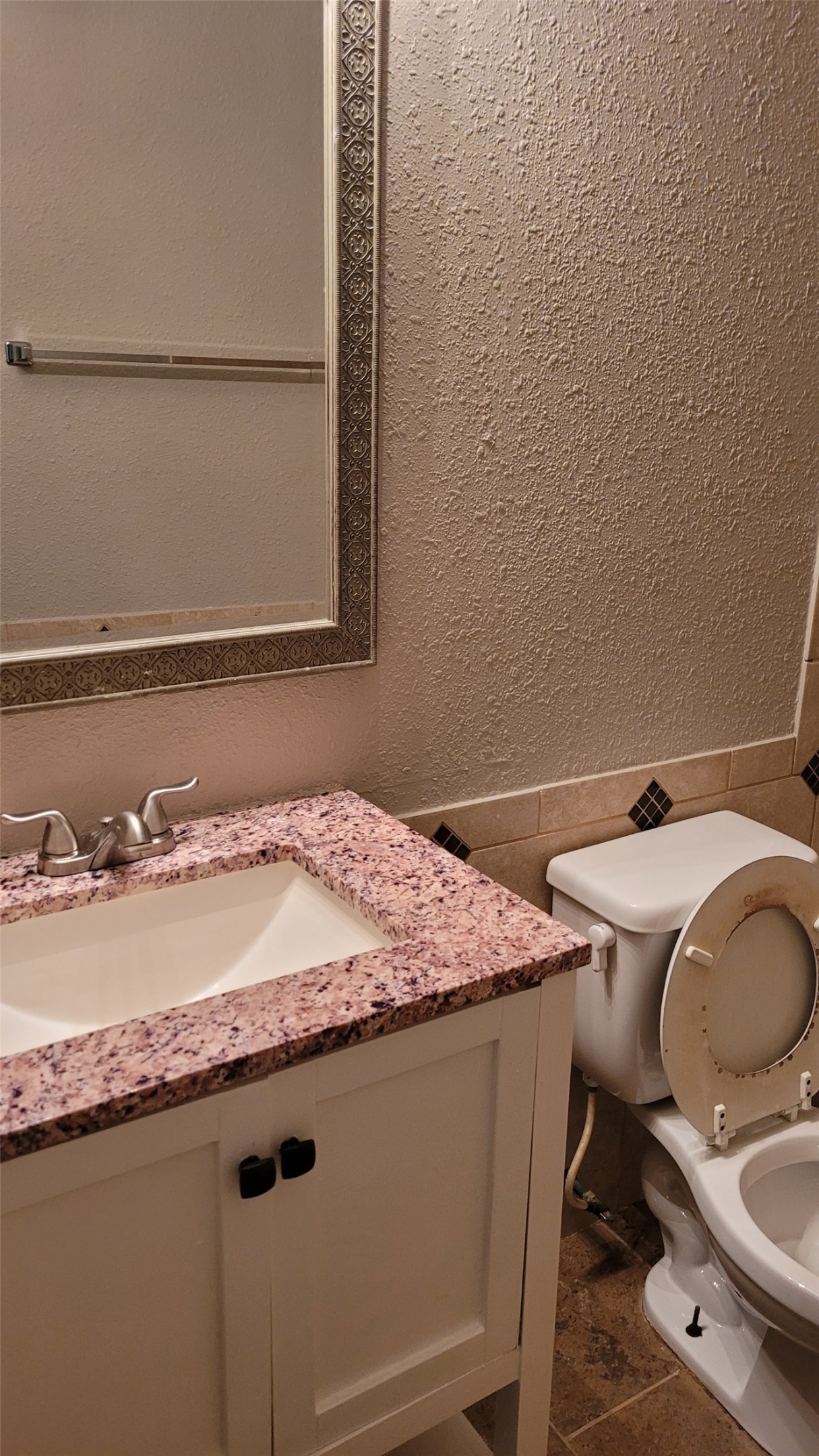 8804 Schick Road, Unit C Austin, TX 78729 - Photo 15 of 26 Half bath featuring a textured wall, vanity, wainscoting, and tile walls