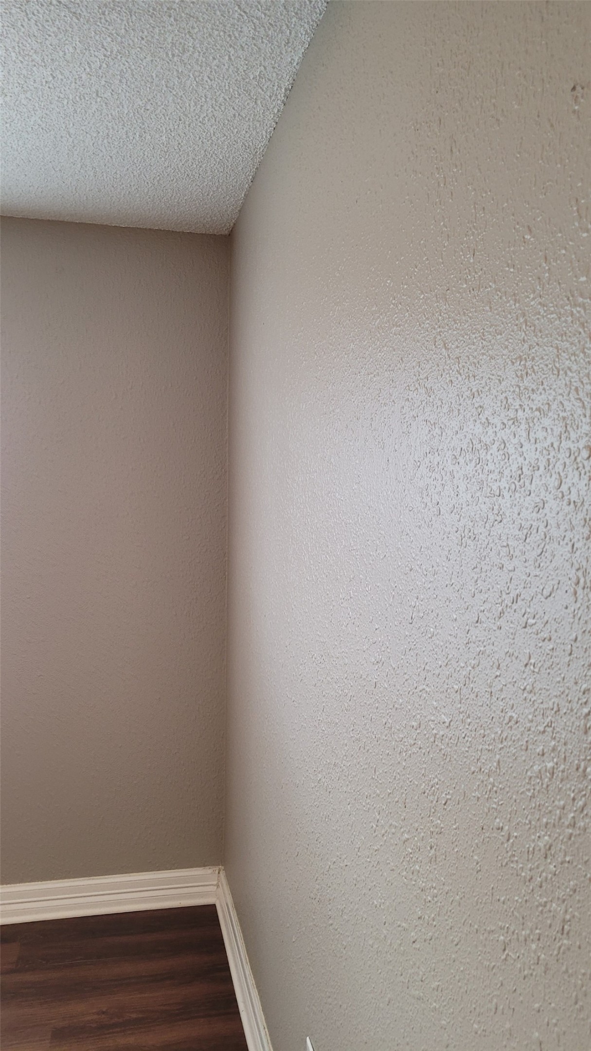 8804 Schick Road, Unit C Austin, TX 78729 - Photo 20 of 26 Unfurnished room featuring dark wood finished floors and a textured ceiling