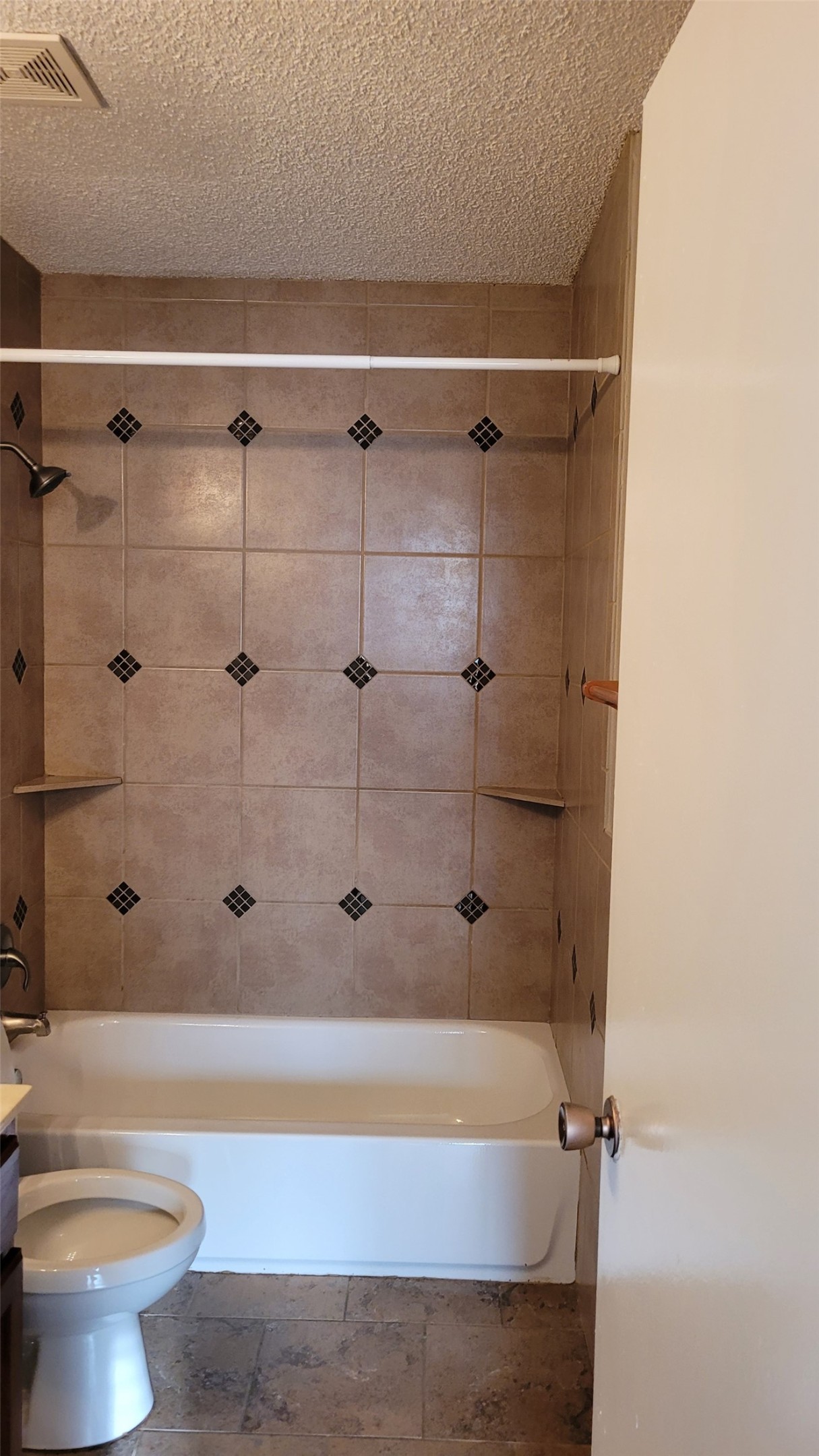 8804 Schick Road, Unit C Austin, TX 78729 - Photo 21 of 26 Bathroom featuring vanity, bathing tub / shower combination, and a textured ceiling