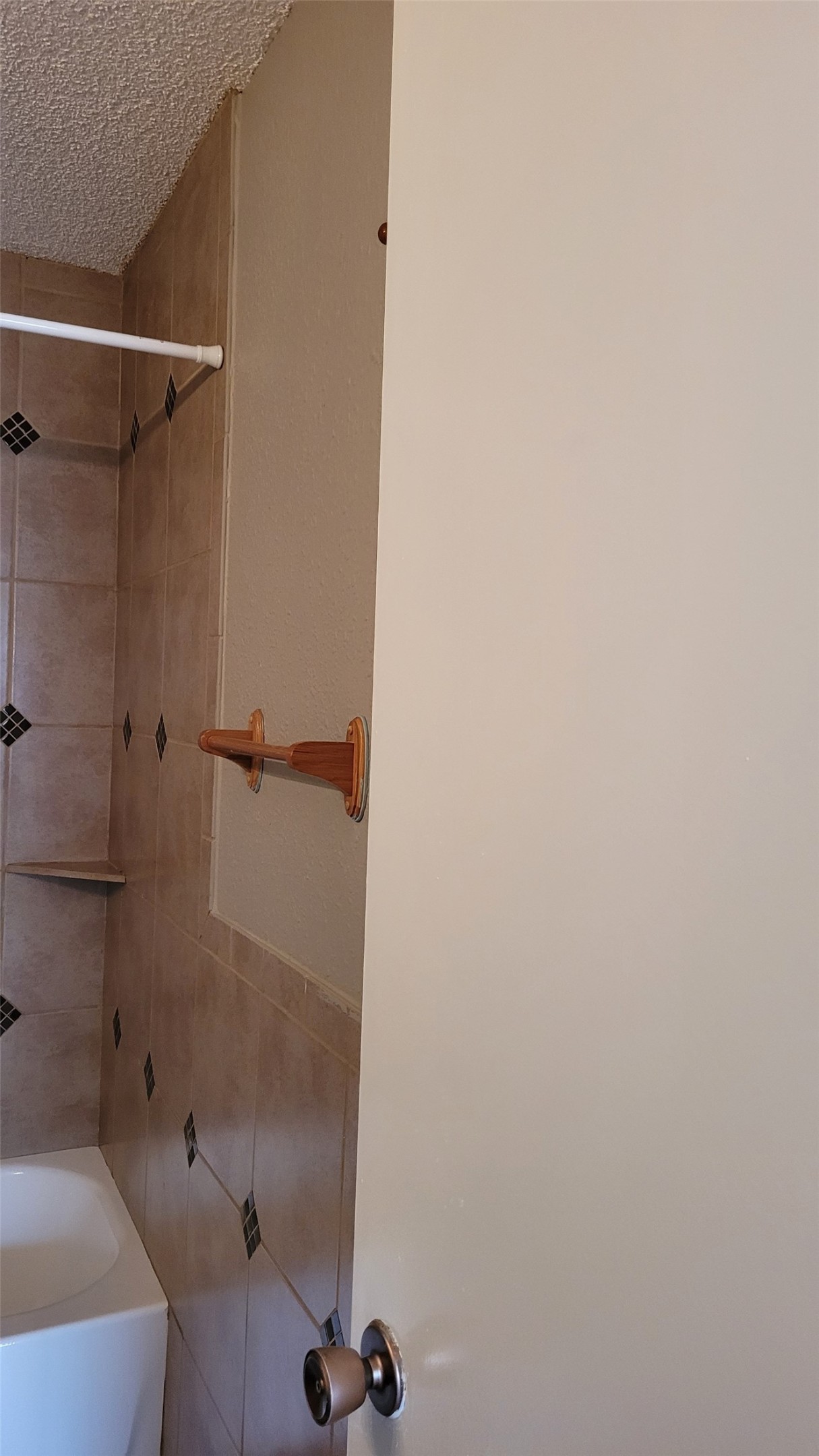 8804 Schick Road, Unit C Austin, TX 78729 - Photo 23 of 26 Full bath with shower / bathtub combination, a textured ceiling, and tile walls