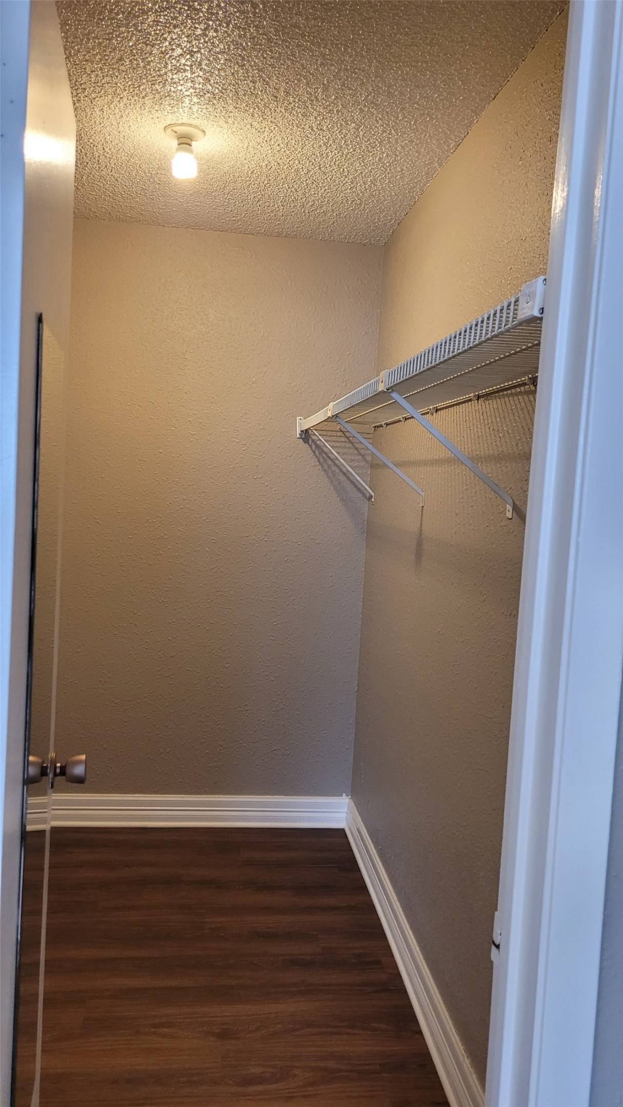 8804 Schick Road, Unit C Austin, TX 78729 - Photo 25 of 26 Walk in closet featuring dark wood-style flooring