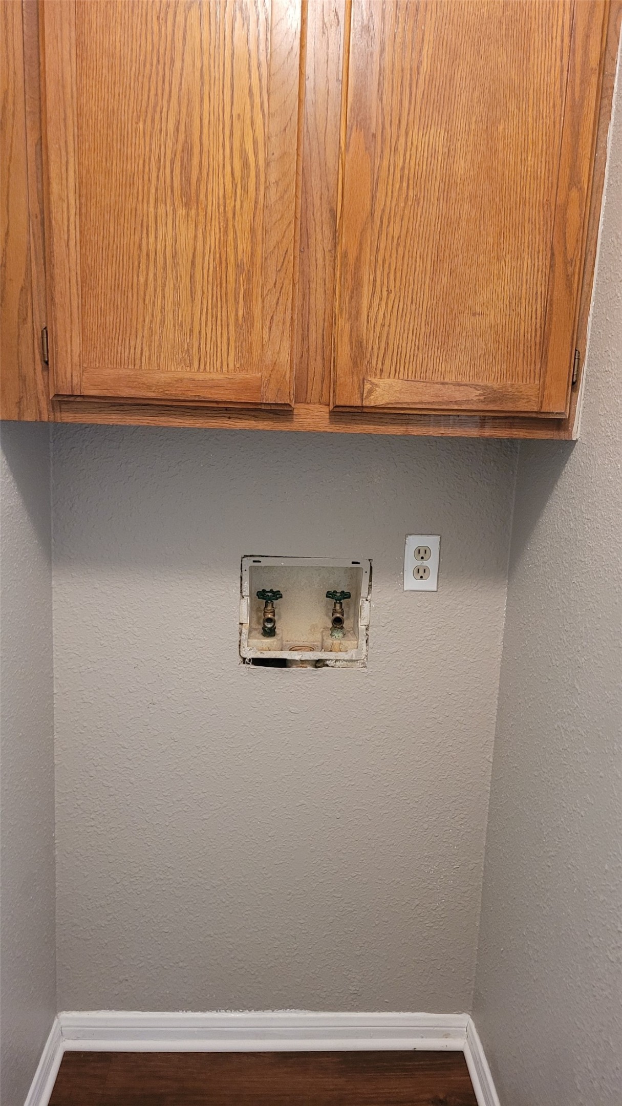 8804 Schick Road, Unit C Austin, TX 78729 - Photo 6 of 26 Laundry room with washer hookup, cabinet space, dark wood-type flooring, and a textured wall