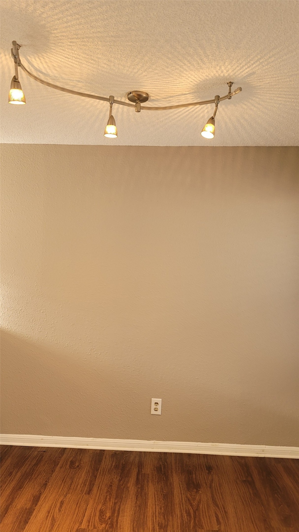 8804 Schick Road, Unit C Austin, TX 78729 - Photo 7 of 26 Spare room with dark wood finished floors and a textured ceiling