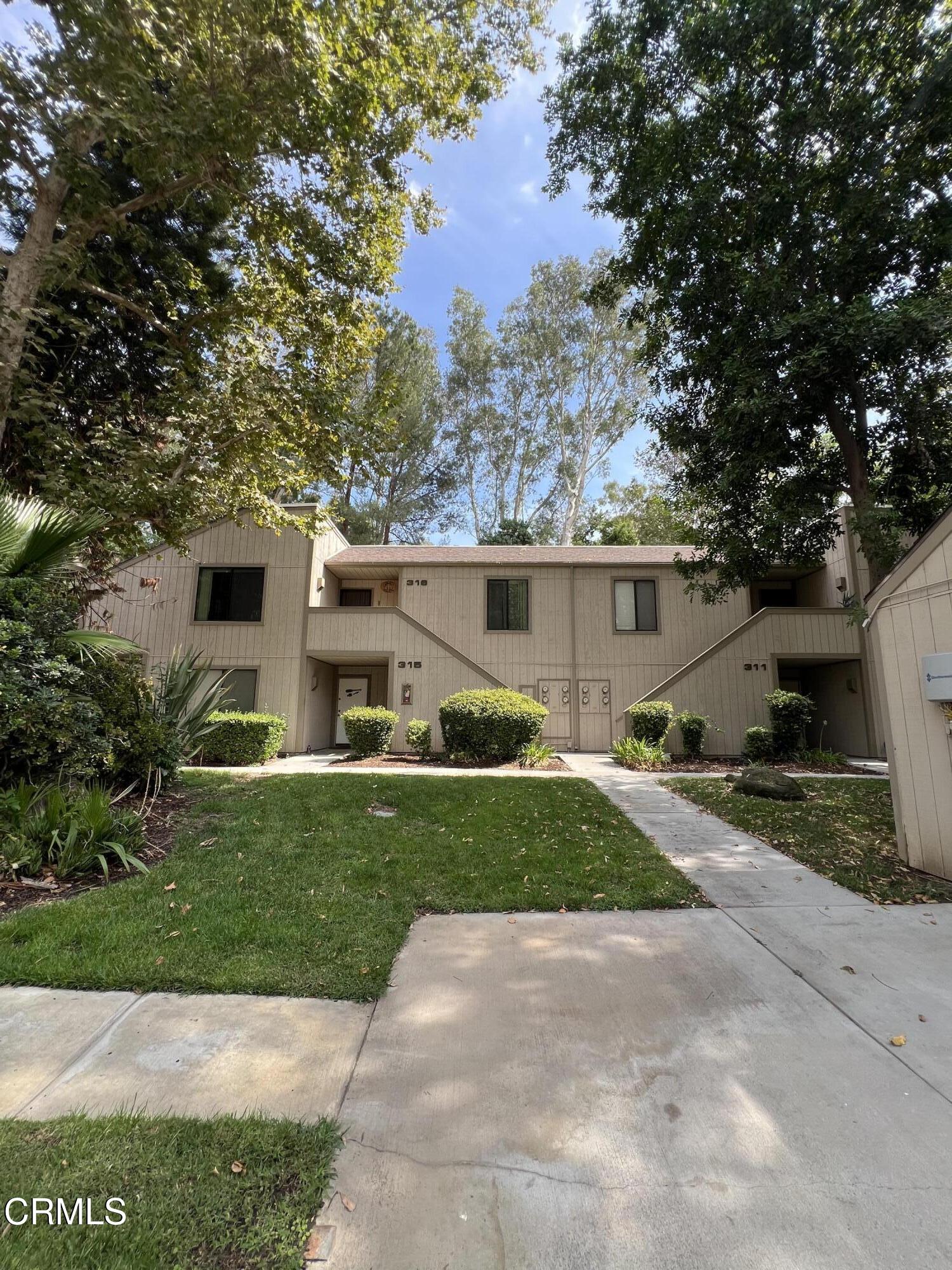 600 Central Avenue, Unit 316 Riverside, CA 92507 - Photo 4 of 9 a front view of a house with a yard and garage