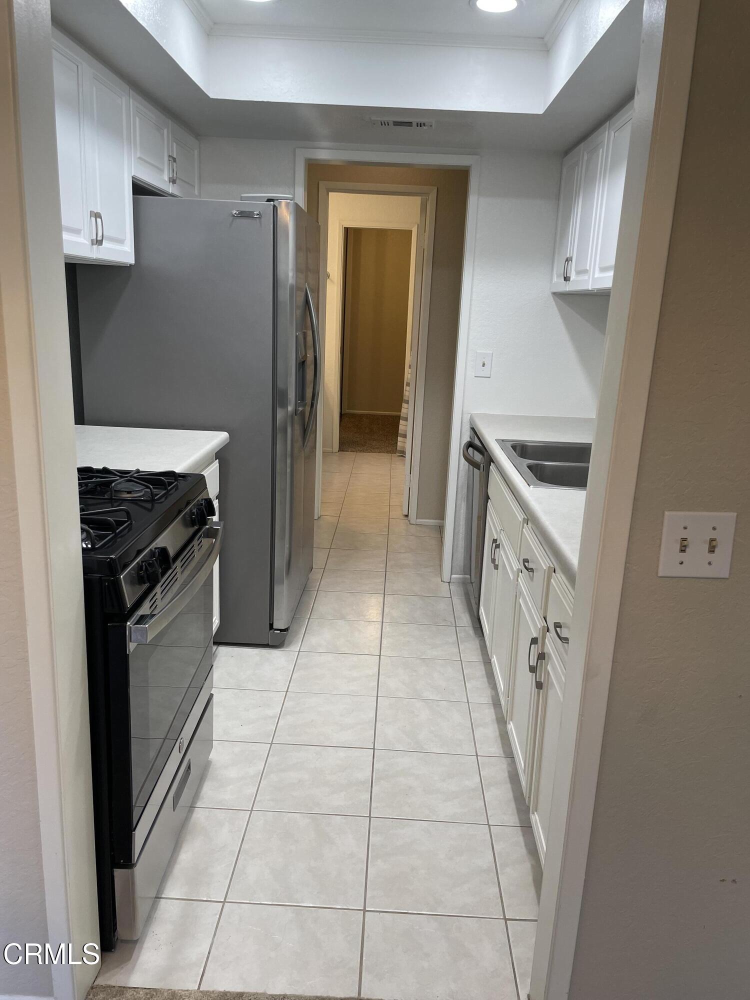 600 Central Avenue, Unit 316 Riverside, CA 92507 - Photo 9 of 9 a kitchen with granite countertop a stove and a refrigerator