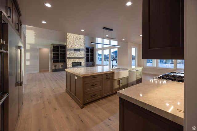 904 South 1900 West Layton, UT 84041 - Photo 18 of 19 Kitchen with a spacious island, open floor plan, light wood-style tile flooring, light counters