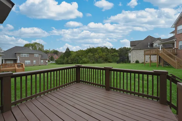 a view of a hallway with wooden floor and stairs
