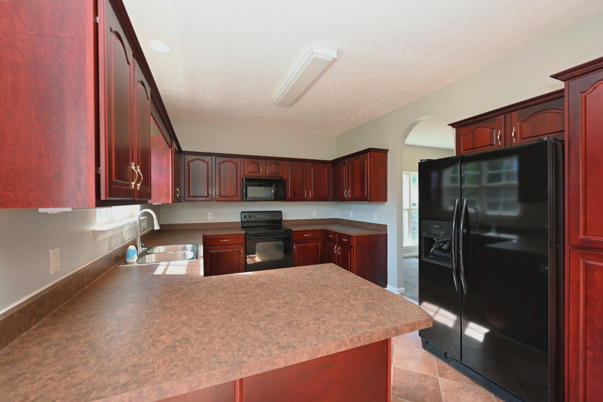 7309 Smokey Hill Road Antioch, TN 37013 - Photo 32 of 88 a kitchen with stainless steel appliances granite countertop a refrigerator a stove and a sink with wooden cabinets