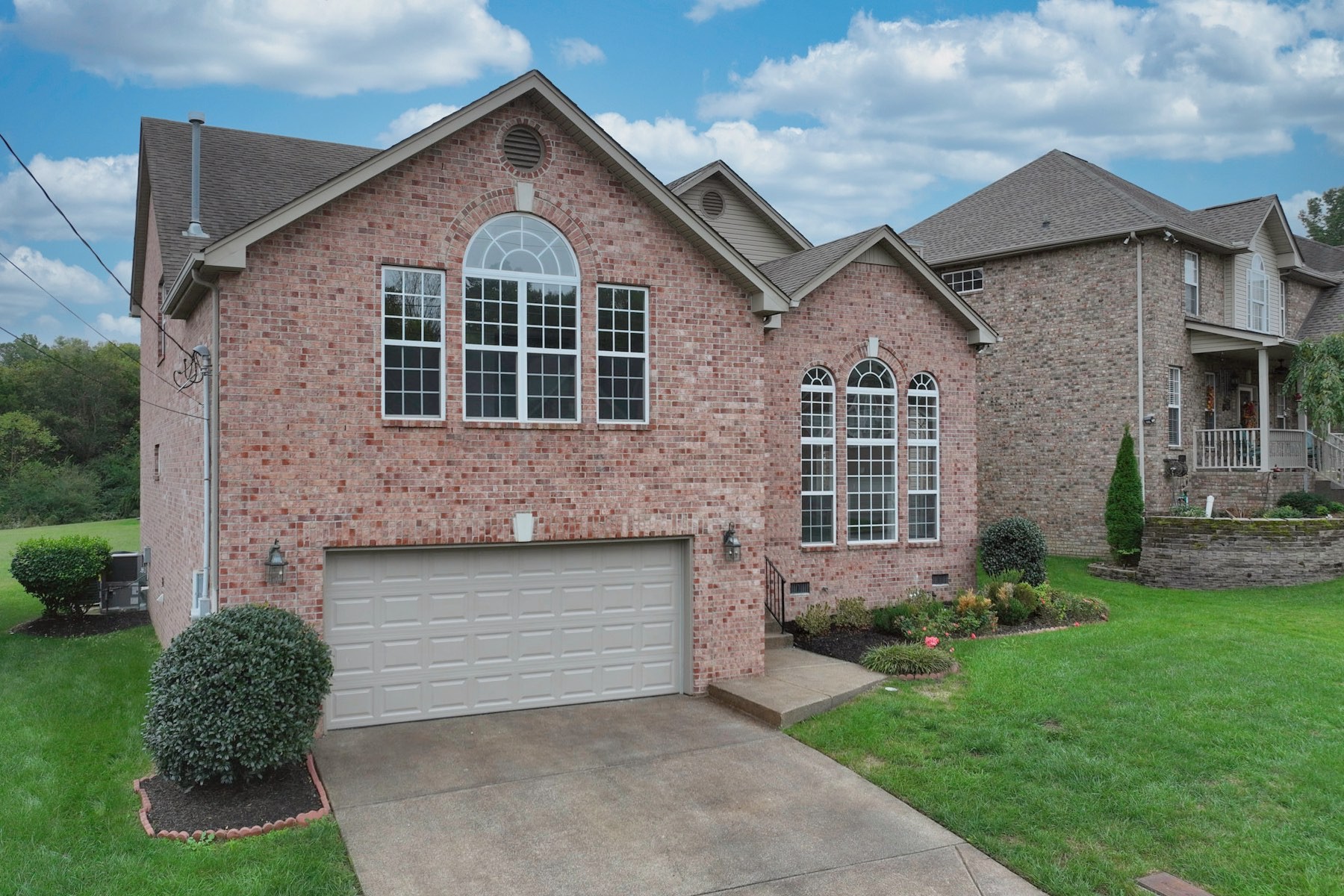 7309 Smokey Hill Road Antioch, TN 37013 - Photo 4 of 88 a front view of a house with a garden and plants