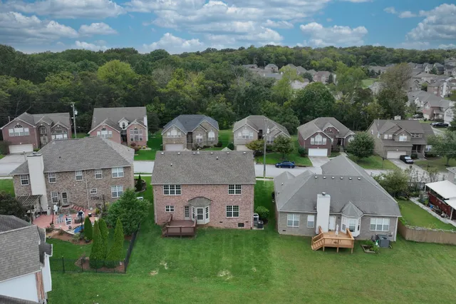 an aerial view of a house with a garden and a yard