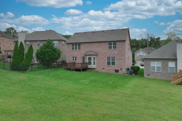 a aerial view of a house with a yard and a garden