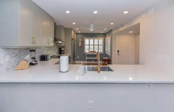 a kitchen with a sink a stove and cabinets