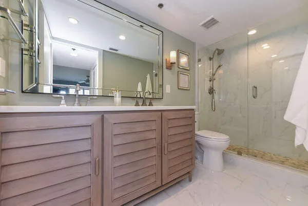 a bathroom with a double vanity sink toilet and shower